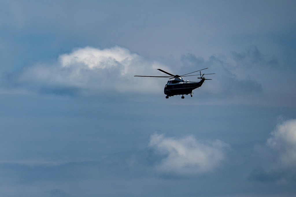 Marine One, with President Donald Trump aboard, flies past the Washington Monument after lifting off from the Ellipse, Tuesday, Aug. 4, 2026, in Washington. (AP Photo/Alex Brandon)