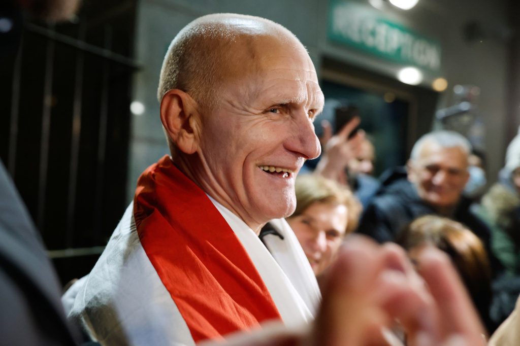 FILE - Nobel Peace Prize laureate Ales Bialiatski, one of released Belarusian prisoners, smiles surrounded by his supporters as he arrives at the U.S. Embassy in Vilnius, Lithuania, on Saturday, Dec. 13, 2025. (AP Photo/Mindaugas Kulbis, File)