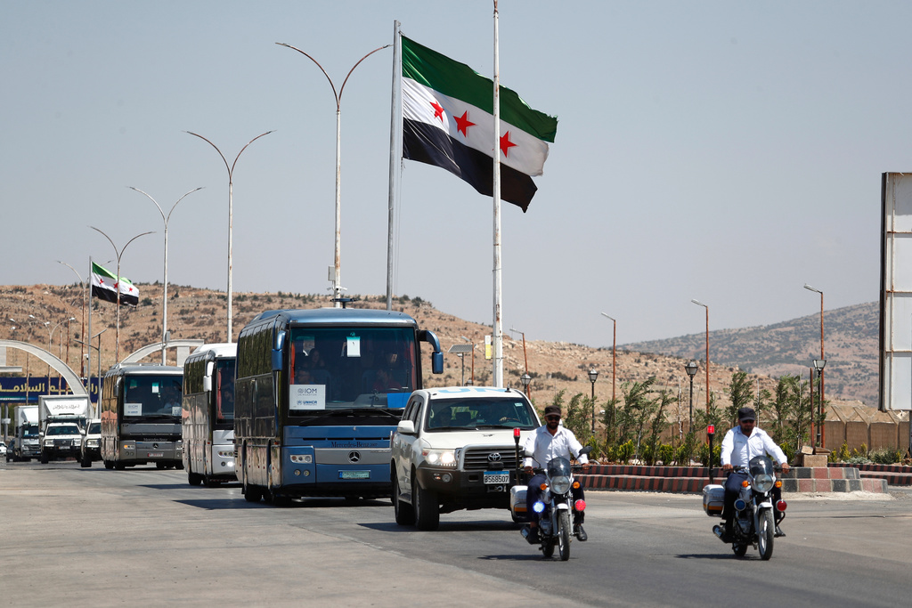 FILE - A convoy of buses carry Syrian refugees who return home from Lebanon, arrive at the Syrian border crossing point, in Jdeidet Yabous, Syria, Tuesday, July 29, 2025. (AP Photo/Omar Sanadiki, File)