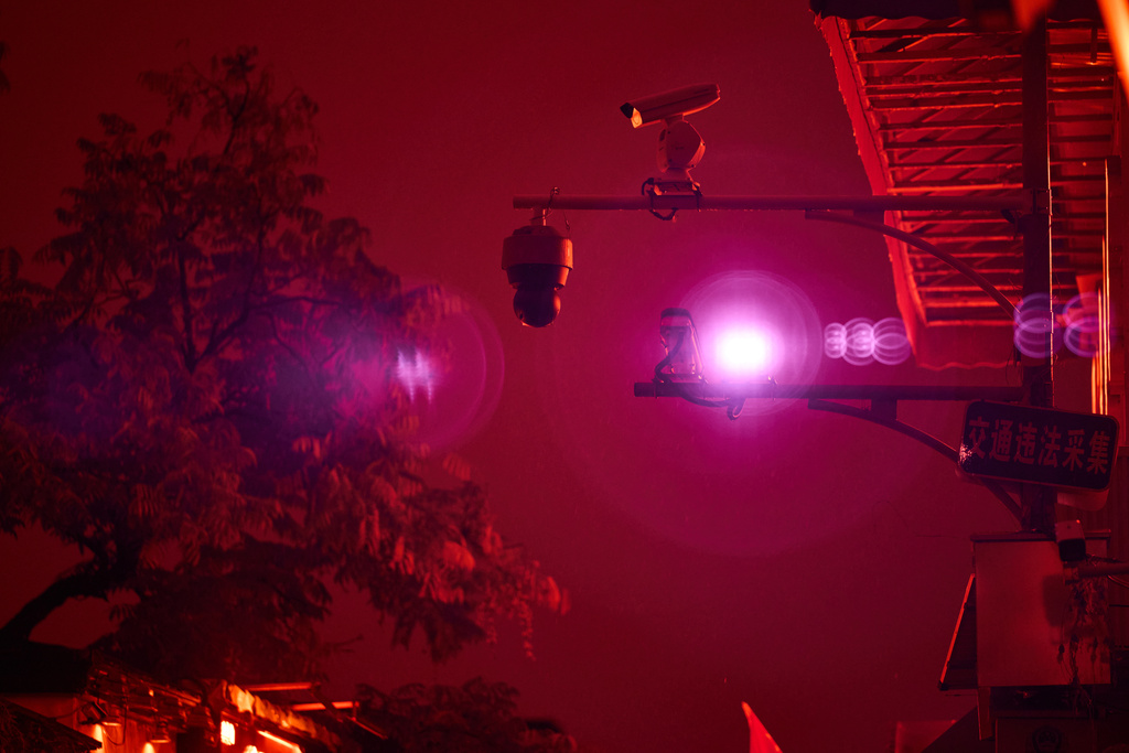 An infrared beam of light shines from a security camera watching over the Wudaoying alley in Beijing, Oct. 10, 2025. (AP Photo/Ng Han Guan)