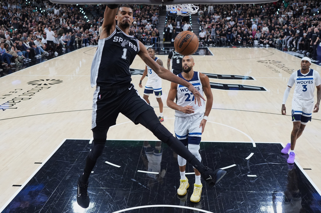 San Antonio Spurs forward Victor Wembanyama (1) scores against the Minnesota Timberwolves during the first half of Game 5 of an NBA basketball second-round playoffs series in Minneapolis, Tuesday, May 12, 2026. (AP Photo/Eric Gay)