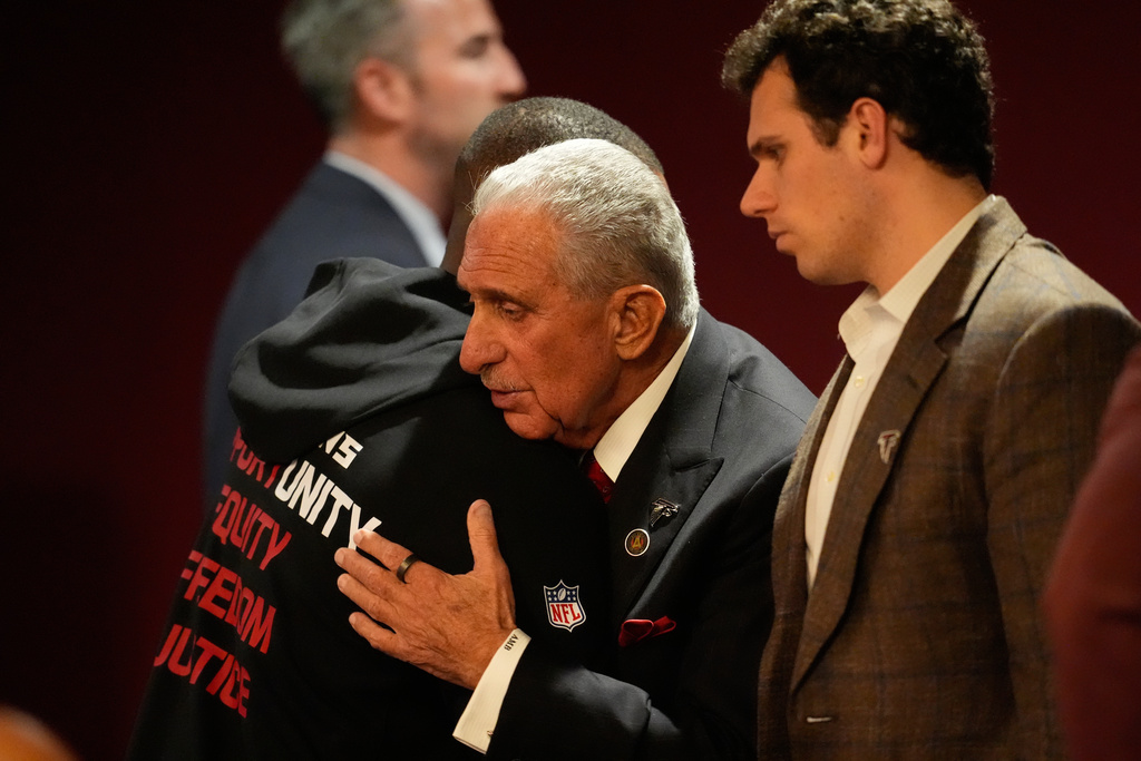 Atlanta Falcons owner Arthur Blank, right, hugs head coach Raheem Morris after an NFL football game against the New Orleans Saints, Sunday, Jan. 4, 2026, in Atlanta. (AP Photo/Mike Stewart)