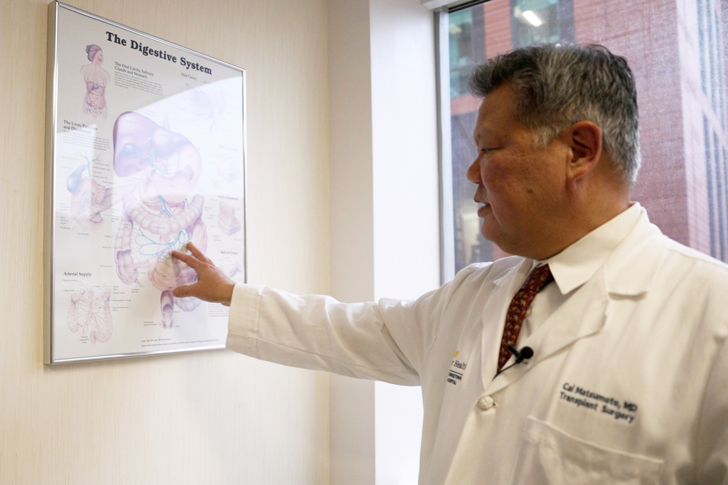 Dr. Cal Matsumoto, a MedStar Georgetown University Hospital transplant surgeon, gestures to a chart on the digestive system on March 4, 2026, in Washington. (AP Photo/Shelby Lum)