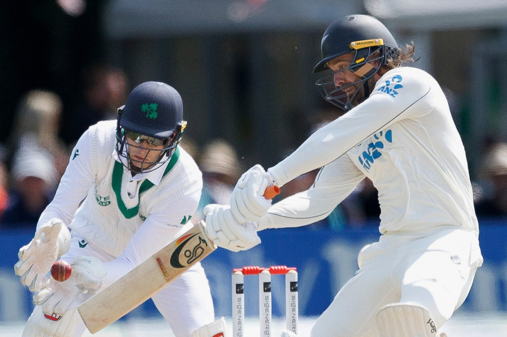 New Zealand's Tom Blundell bats in front of Ireland's wicket keeper Lorcan Tucker on day two of the test match between Ireland and New Zealand at Stormont Cricket Ground in Belfast, Northern Ireland, Thursday May 28, 2026. (Liam McBurney/PA via AP)