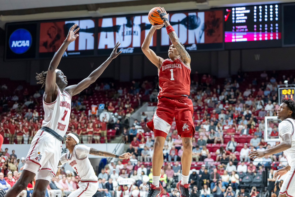 Arkansas guard Meleek Thomas (1) shoots a jump shot over Alabama forward Taylor Bol Bowen (7) during the first half of an NCAA college basketball game Wednesday, Feb. 18, 2026, in Tuscaloosa, Ala. (AP Photo/Vasha Hunt)