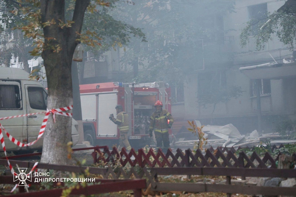 In this photo provided by the Ukrainian Emergency Services on Saturday, Sept. 20, 2025, rescue workers put out a fire of a residential house damaged by a Russian strike on Dnipro, Ukraine. (Ukrainian Emergency Service via AP)
