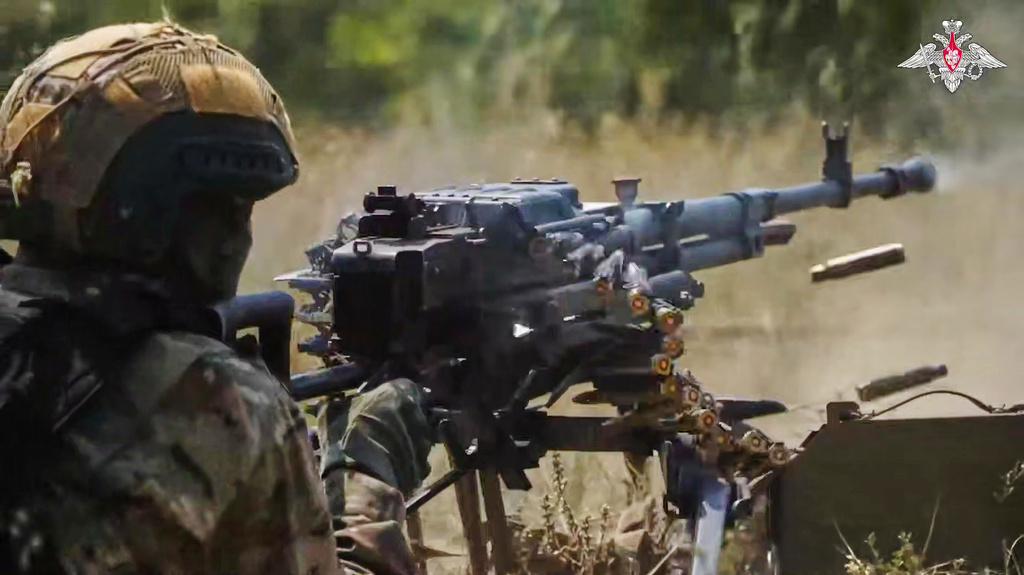 In this photo taken from video distributed by Russian Defense Ministry Press Service on Sunday, Aug. 17, 2025, a Russian soldier fires during a practice at a training ground on an undisclosed location in Ukraine. (Russian Defense Ministry Press Service via AP)