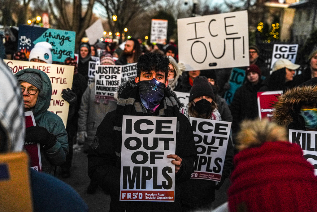 People participate in an anti-ICE protest outside of the Governors Residence, Friday, Feb. 6, 2026, in St. Paul, Minn. (AP Photo/Ryan Murphy)