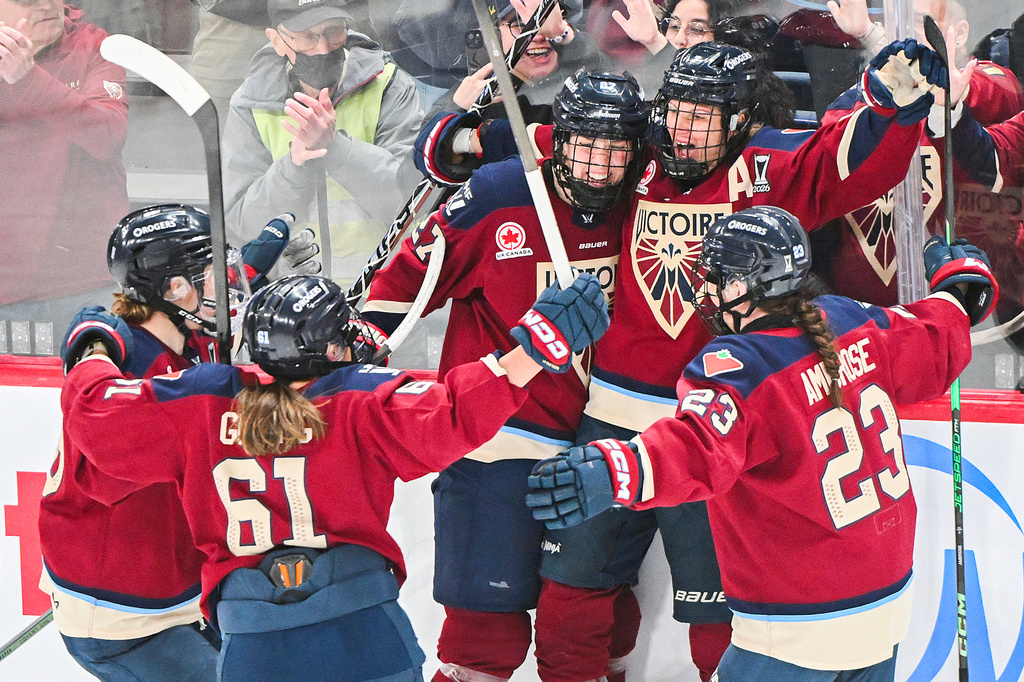 Montreal Victoire's Laura Stacey (7) celebrates with teammates after scoring against the Minnesota Frost during the third period of a PWHL playoff hockey game in Laval, Quebec Saturday, May 2, 2026. (Graham Hughes/The Canadian Press via AP)