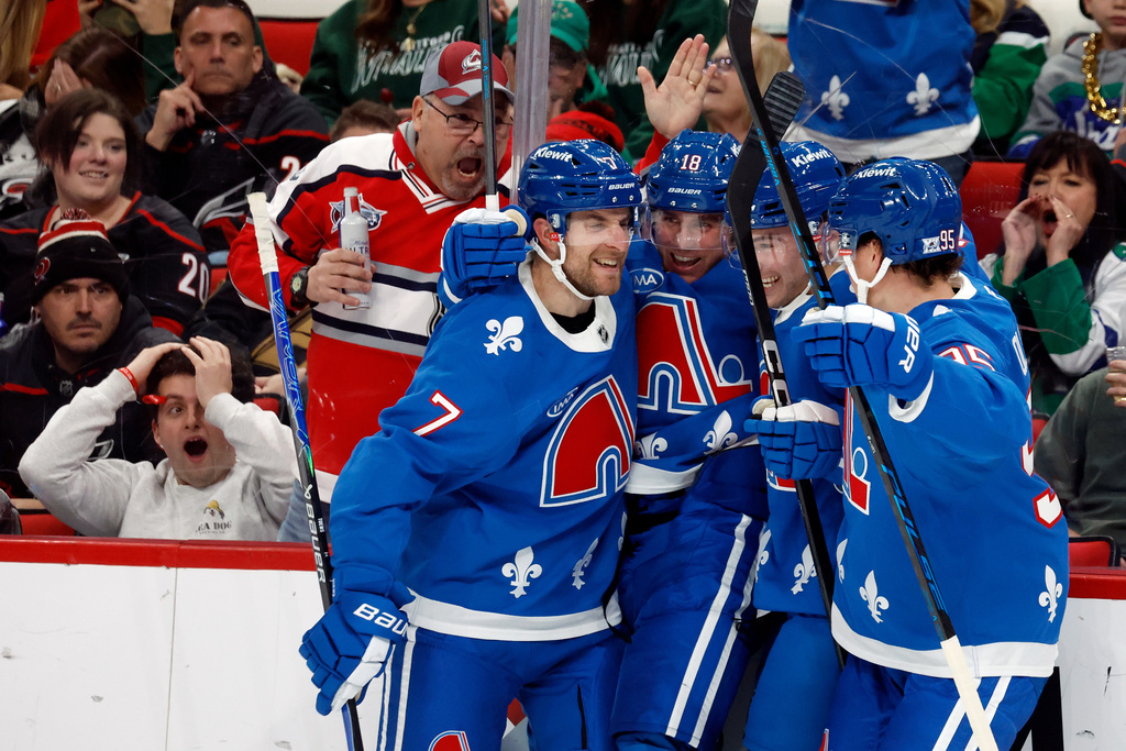 Colorado Avalanche teammates celebrate after a goal by Jack Drury (18) during the third period of an NHL hockey game against the Carolina Hurricanes in Raleigh, N.C., Saturday, Jan. 3, 2026. (AP Photo/Karl DeBlaker)