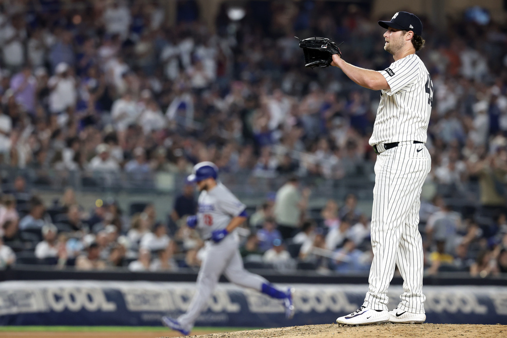 New York Yankees pitcher Gerrit Cole, right, reacts after giving up a two-run home run to Los Angeles Dodgers' Max Muncy during the seventh inning of a baseball game Friday, July 17, 2026, in New York. (AP Photo/Adam Hunger)