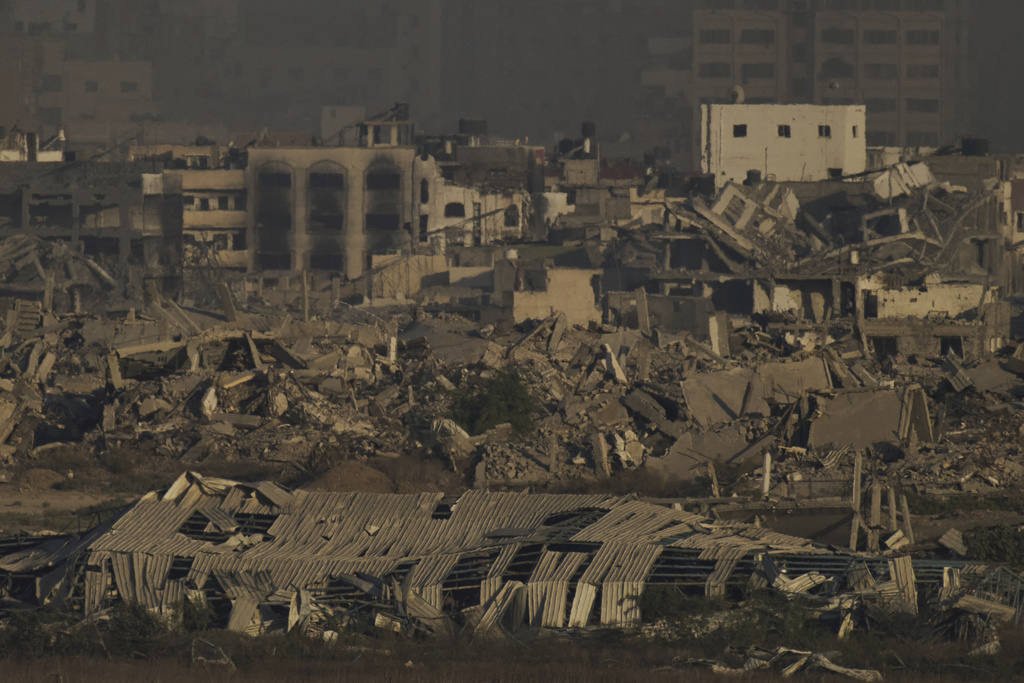 Buildings that were destroyed during the Israeli ground and air operations stand in the northern Gaza Strip as seen from southern Israel, Saturday, Aug. 30, 2025. (AP Photo/Leo Correa)