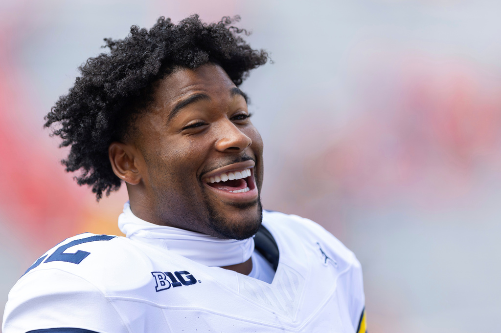 FILE - Michigan running back Justice Haynes smiles with teammates while warming up before playing against Nebraska in an NCAA college football game Saturday, Sept. 20, 2025, in Lincoln, Neb. (AP Photo/Rebecca S. Gratz, File)
