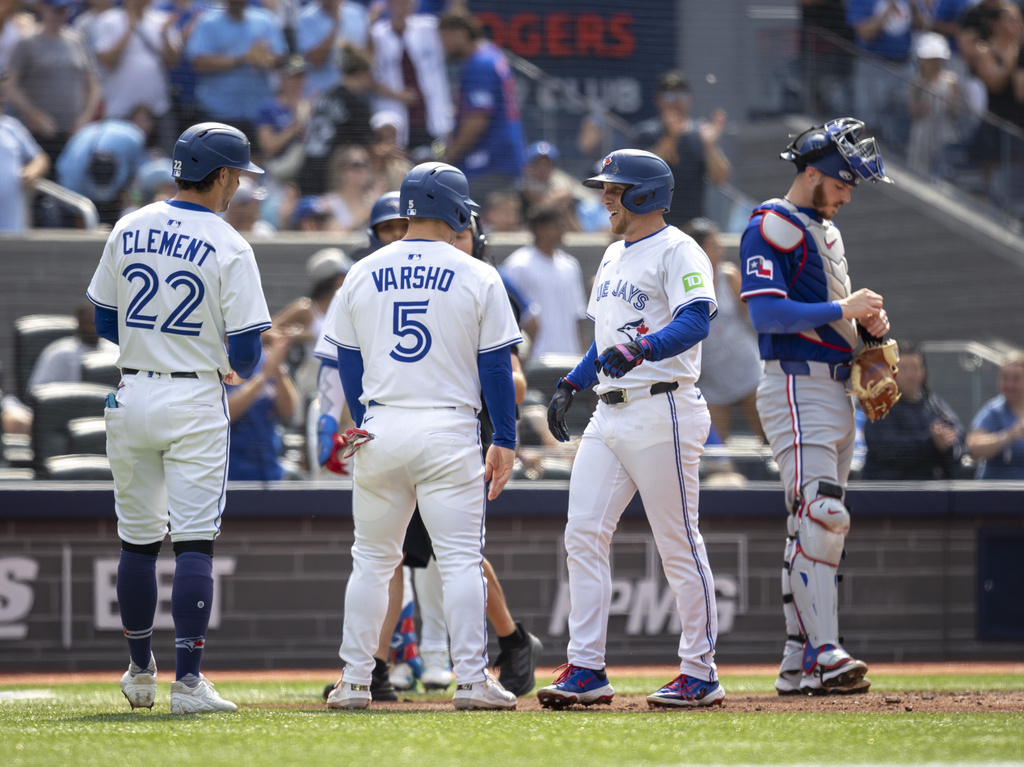 Toronto Blue Jays' Myles Straw (3) celebrates his home run with teammates Ernie Clement (22) and Daulton Varsho (5) during the second inning of a baseball game against the Texas Rangers in Toronto, Saturday, Aug. 16, 2025. (Tara Walton/The Canadian Press via AP)