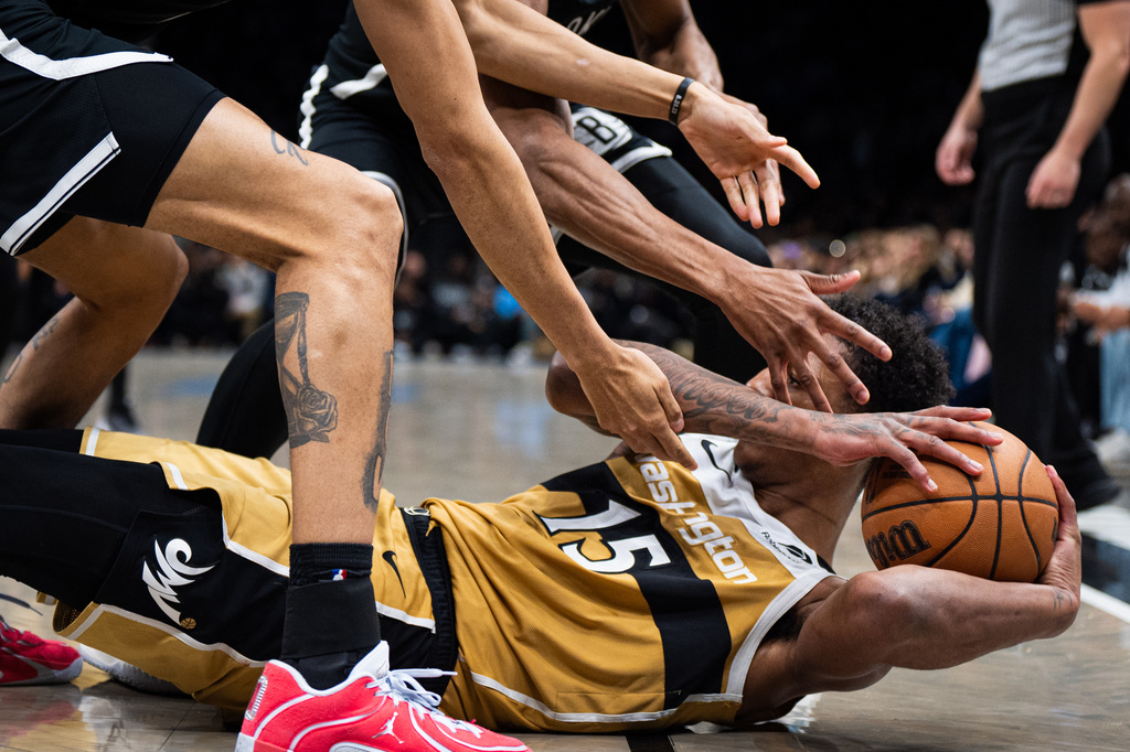 Washington Wizards forward Julian "Juju" Reese (15) fights to keep hold of the ball during the second half of an NBA basketball game against the Brooklyn Nets, Sunday, April 5, 2026, in New York. (AP Photo/Angelina Katsanis)