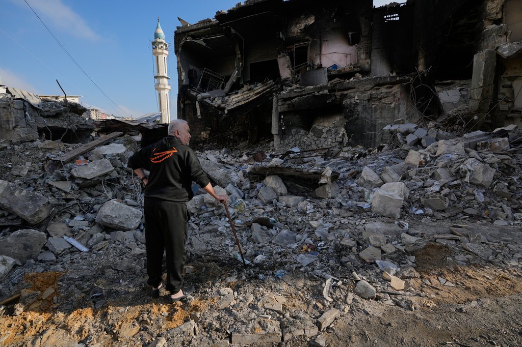 Kamal al-Kamal, 75, who returned to his village following the announcement of an initial ceasefire agreement between the United States and Iran, checks his destroyed supermarket in Nabatiyeh town, southern Lebanon, Tuesday, June 16, 2026. (AP Photo/Hussein Malla)
