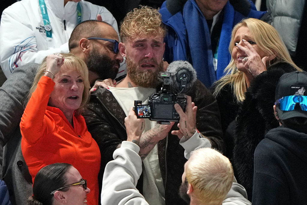 Jake Paul of the U.S., center, cries after his fiancé Jutta Leerdam of the Netherlands won the gold medal in the women's 1,000 meters speedskating race at the 2026 Winter Olympics, in Milan, Italy, Monday, Feb. 9, 2026. (AP Photo/Antonio Calanni)