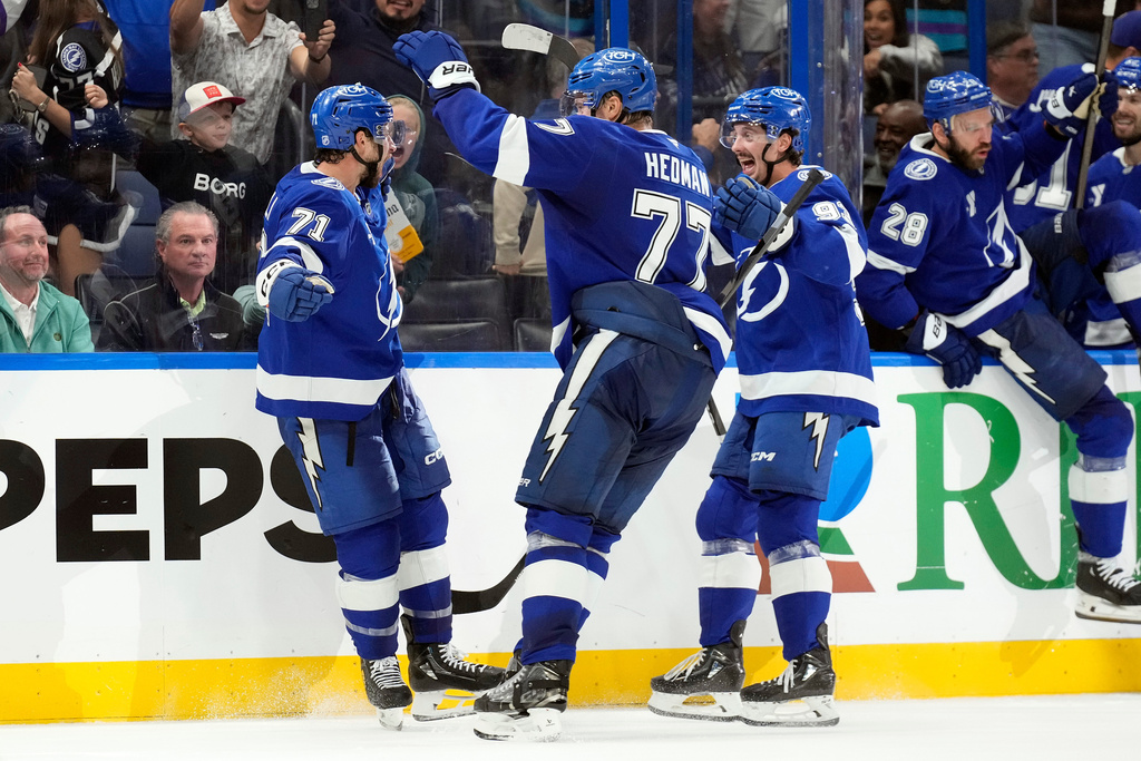 Tampa Bay Lightning center Anthony Cirelli (71) celebrates his game-winning goal against the Dallas Stars with defenseman Victor Hedman (77) and center Gage Goncalves (93) during overtime in an NHL hockey game Thursday, Oct. 30, 2025, in Tampa, Fla. (AP Photo/Chris O'Meara)