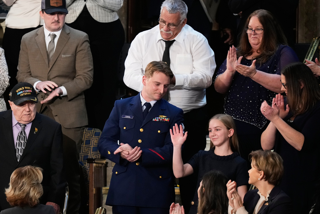 ADDS MILLY CATE'S LAST NAME - Coast Guard Petty Officer Scott Ruskan and Milly Cate McClymond, a camper at Camp Mystic, are recognized during President Donald Trump's State of the Union address to a joint session of Congress in the House chamber at the U.S. Capitol in Washington, Tuesday, Feb. 24, 2026. (AP Photo/Alex Brandon)