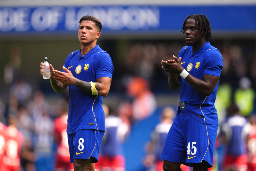 Chelsea's Enzo Fernandez, left, and Romeo Lavia applaud the fans after the final whistle in the pre-season friendly match between Real Sociedad and Chelsea at Stamford Bridge, London, on Saturday, Aug. 15, 2026. (John Walton/PA via AP)