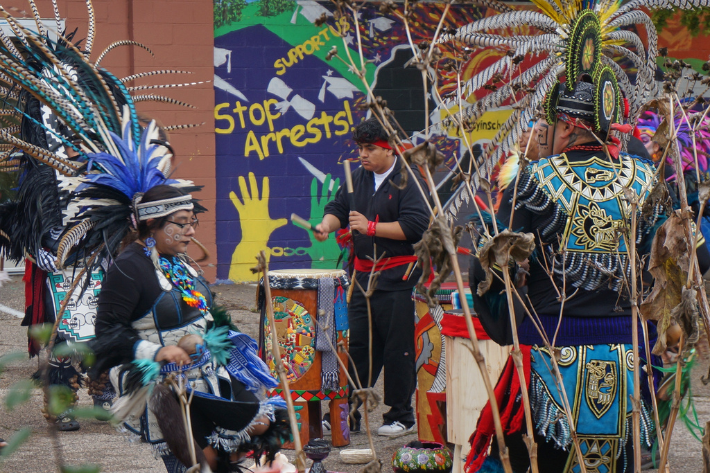 Aztec dance groups perform outside El Colegio High School in Minneapolis during a commemoration of Día de Muertos (Day of the Dead) on Saturday, Nov. 1, 2025. (AP Photo/Giovanna Dell'Orto)