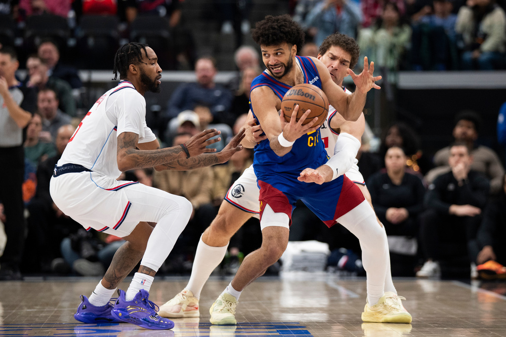 Los Angeles Clippers forward Derrick Jones Jr., left, and center Brook Lopez, back right, defend against Denver Nuggets guard Jamal Murray, front right, during the first half of an NBA basketball game Thursday, Feb. 19, 2026, in Inglewood, Calif. (AP Photo/Kyusung Gong)