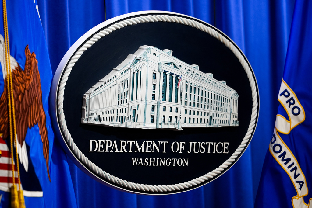 The U.S. Department of Justice logo is before a news conference, Monday, May 4, 2026, in Washington. (AP Photo/Julia Demaree Nikhinson)