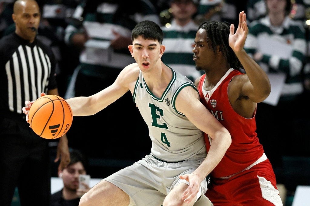 Eastern Michigan forward Mohammad Habhab (4) drives against Miami (OH) forward Antwone Woolfolk, right, during the first half of an NCAA college basketball game Tuesday, Feb. 24, 2026, in Ypsilanti, Mich. (AP Photo/Duane Burleson)
