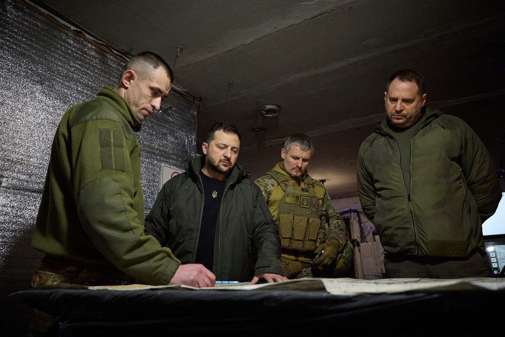In this photo provided by the Ukrainian Presidential Press Office, Ukrainian President Volodymyr Zelenskyy, 2nd left, looks at a map during his visit to Ukrainian 110th mechanised brigade in Avdiivka, the site of fierce battles with the Russian troops in the Donetsk region, Ukraine, Friday, Dec. 29, 2023. Right is head of the Presidential Office Andriy Yermak; deputy head of the Presidential Office Roman Mashovets is 2nd right. (Ukrainian Presidential Press Office via AP)