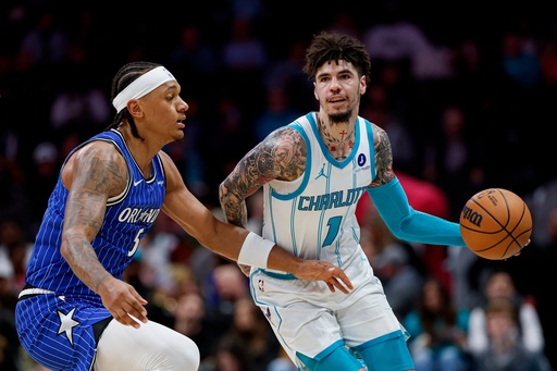 Charlotte Hornets guard LaMelo Ball (1) moves the ball against Orlando Magic forward Paolo Banchero, left, during the first half of an NBA basketball game in Charlotte, N.C., Thursday, Oct. 30, 2025. (AP Photo/Nell Redmond) Charlotte Hornets guard LaMelo Ball (1) moves the ball against Orlando Magic forward Paolo Banchero, left, during the first half of an NBA basketball game in Charlotte, N.C., Thursday, Oct. 30, 2025. (AP Photo/Nell Redmond)