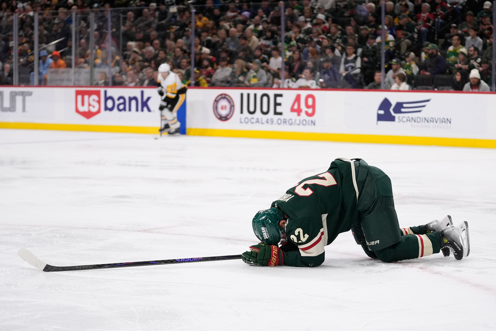 Minnesota Wild right wing Danila Yurov (22) lays on the ground after sustaining an injury during the second period of an NHL hockey game against the Pittsburgh Penguins, Thursday, Oct. 30, 2025, in St. Paul, Minn. (AP Photo/Abbie Parr)