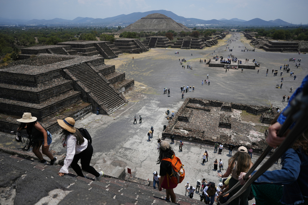 Tourists visit the Teotihuacan pyramids after the archaeological site reopened two days after a gunman opened fire, killing a Canadian tourist, outside Mexico City, Wednesday, April 22, 2026. (AP Photo/Eduardo Verdugo)