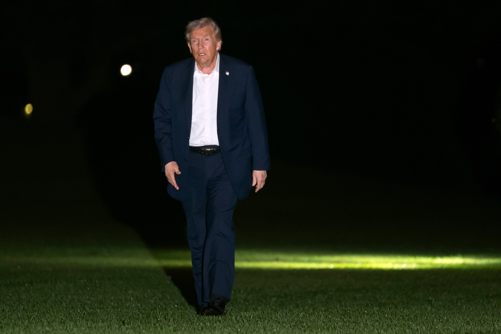 President Donald Trump walks across the South Lawn of the White House, early Tuesday, Oct. 14, 2025, in Washington, after returning from a trip to Israel and Egypt. (AP Photo/Mark Schiefelbein)