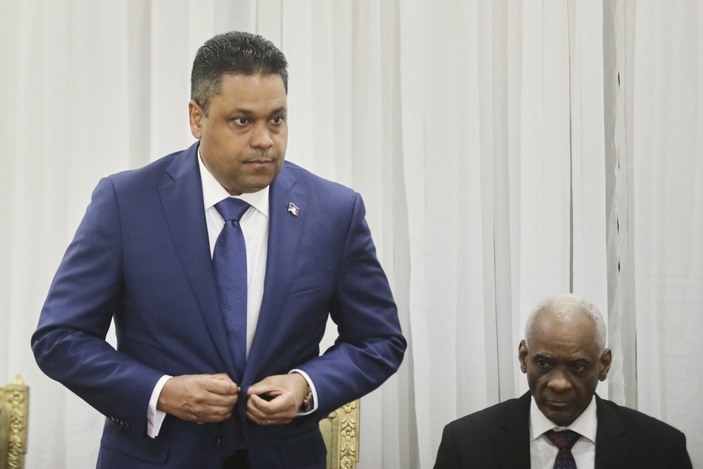 Laurent Saint-Cyr, left, attends the ceremony for his appointment as president of the Transitional Council in Port-au-Prince, Haiti, Thursday, Aug. 7, 2025. (AP Photo/Odelyn Joseph)