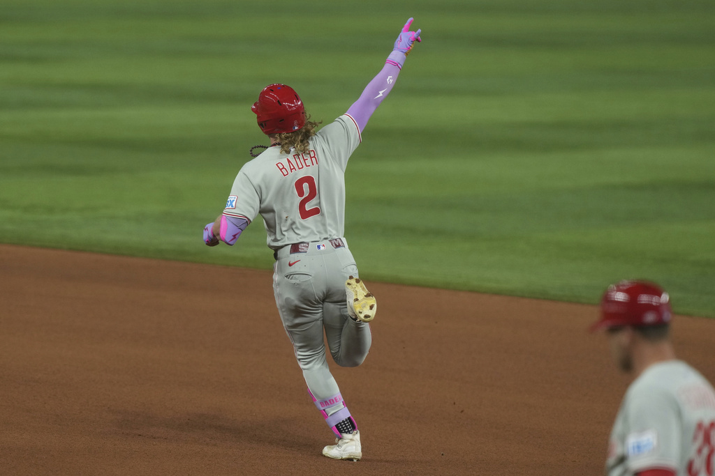 Philadelphia Phillies' Harrison Bader (2) gestures to the bullpen after hitting a home run during the forth inning of a baseball game against the Miami Marlins Friday, Sept. 5, 2025, in Miami. (AP Photo/Marta Lavandier)