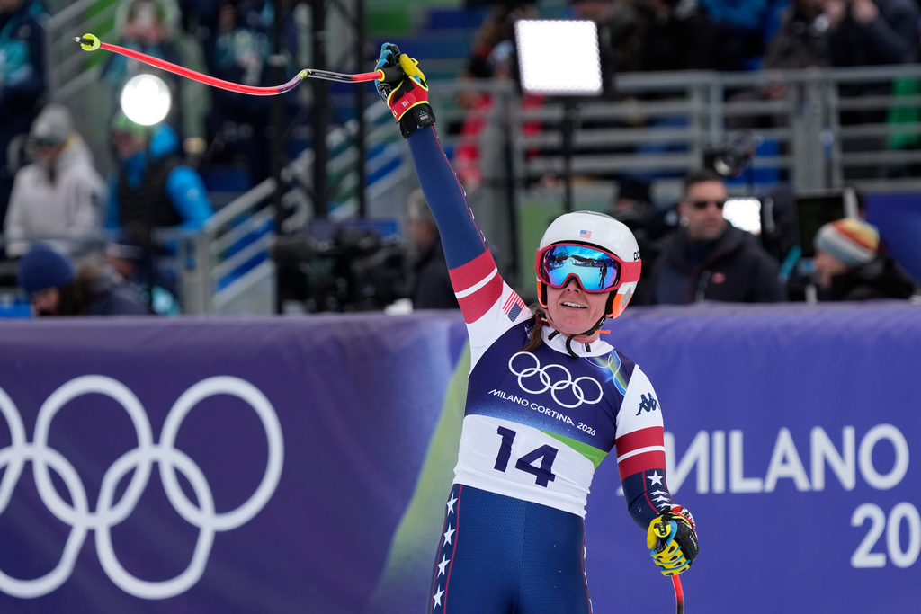 United States' Breezy Johnson celebrates at the finish area of an alpine ski, downhill portion of a women's team combined race, at the 2026 Winter Olympics, in Cortina d'Ampezzo, Italy, Tuesday, Feb. 10, 2026. (AP Photo/Andy Wong)