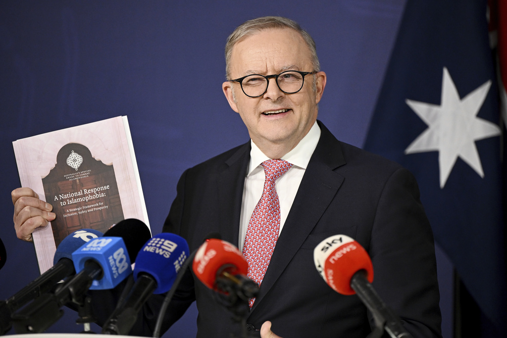 Australian Prime Minister Anthony Albanese holds a copy of the National Response to Islamophobia report as he speaks to the media during a press conference at the Commonwealth Parliamentary Offices in Sydney, Friday, Sept. 12, 2025. (Bianca De Marchi/AAP Image via AP)