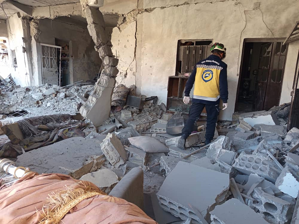 This photo provided by the Syrian Civil Defense White Helmets, A Syrian Civil Defense worker checks a house that was destroyed during an Israeli forces raid in the southern Syrian village of Beit Jin, Syria, Friday, Nov. 28, 2025. (Syrian Civil Defense White Helmets via AP)
