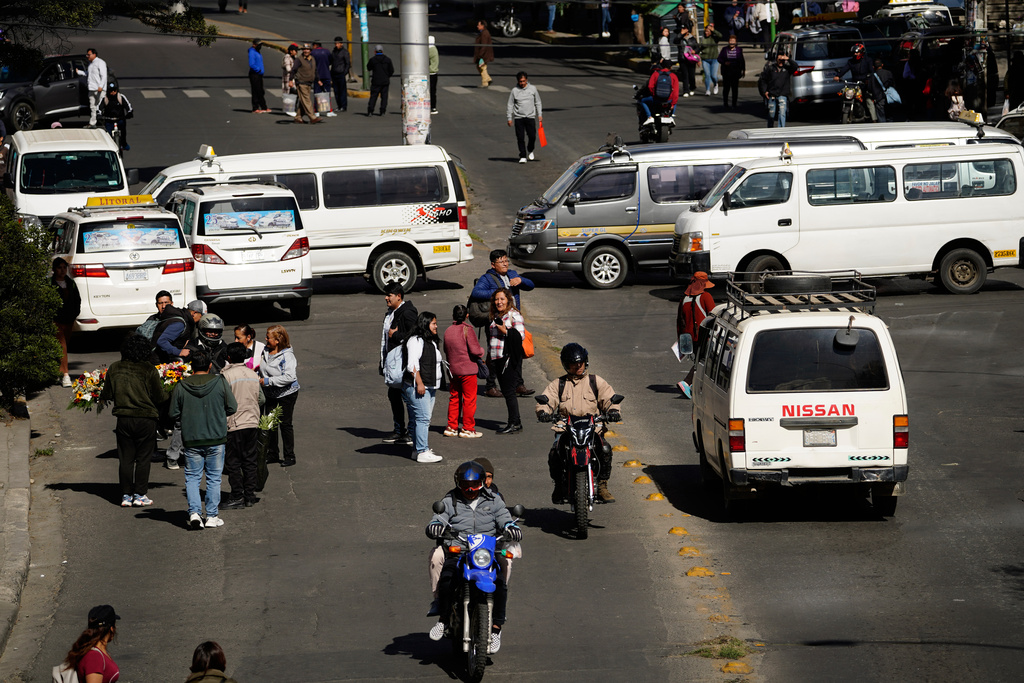 People walk during strike by the public transportation sector in La Paz, Bolivia, Friday, Dec. 19, 2025, after President Rodrigo Paz announced the end of fuel subsidies. (AP Photo/Freddy Barragan)