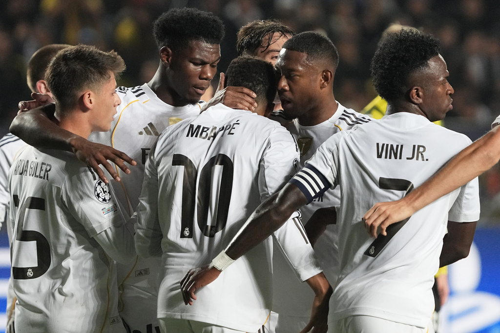 Real Madrid's players celebrate their side's first goal scored by Kylian Mbappe, center, from the penalty spot during the Champions League opening phase soccer match between Kairat Almaty and Real Madrid at the Ortalyk stadium in Almaty, Kazakhstan, Tuesday, Sept. 30, 2025. (AP Photo/Turar Kazangapov)