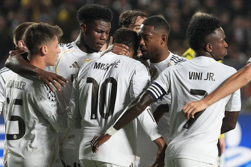 Real Madrid's players celebrate their side's first goal scored by Kylian Mbappe, center, from the penalty spot during the Champions League opening phase soccer match between Kairat Almaty and Real Madrid at the Ortalyk stadium in Almaty, Kazakhstan, Tuesday, Sept. 30, 2025. (AP Photo/Turar Kazangapov) Real Madrid's players celebrate their side's first goal scored by Kylian Mbappe, center, from the penalty spot during the Champions League opening phase soccer match between Kairat Almaty and Real Madrid at the Ortalyk stadium in Almaty, Kazakhstan, Tuesday, Sept. 30, 2025. (AP Photo/Turar Kazangapov)