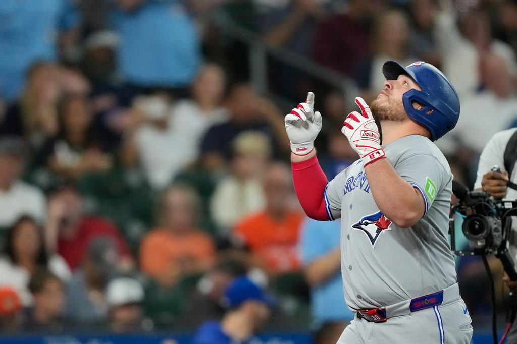 Toronto Blue Jays' Alejandro Kirk celebrates after hitting a home run against the Houston Astros during the second inning of a baseball game Monday, Aug. 3, 2026, in Houston. (AP Photo/David J. Phillip)