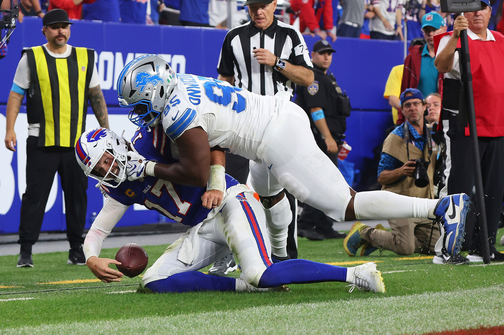 Buffalo Bills quarterback Josh Allen (17) scores a rushing touchdown as Detroit Lions' Levi Onwuzurike defends during the second half of an NFL football game in Orchard Park, N.Y., Thursday, Sept. 17, 2026. (AP Photo/Jeffrey T. Barnes)