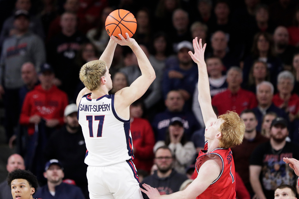 Gonzaga guard Mario Saint-Supery (17) shoots while pressured by Saint Mary's guard Joshua Dent during the second half of an NCAA college basketball game, Saturday, Jan. 31, 2026, in Spokane, Wash. (AP Photo/Young Kwak)