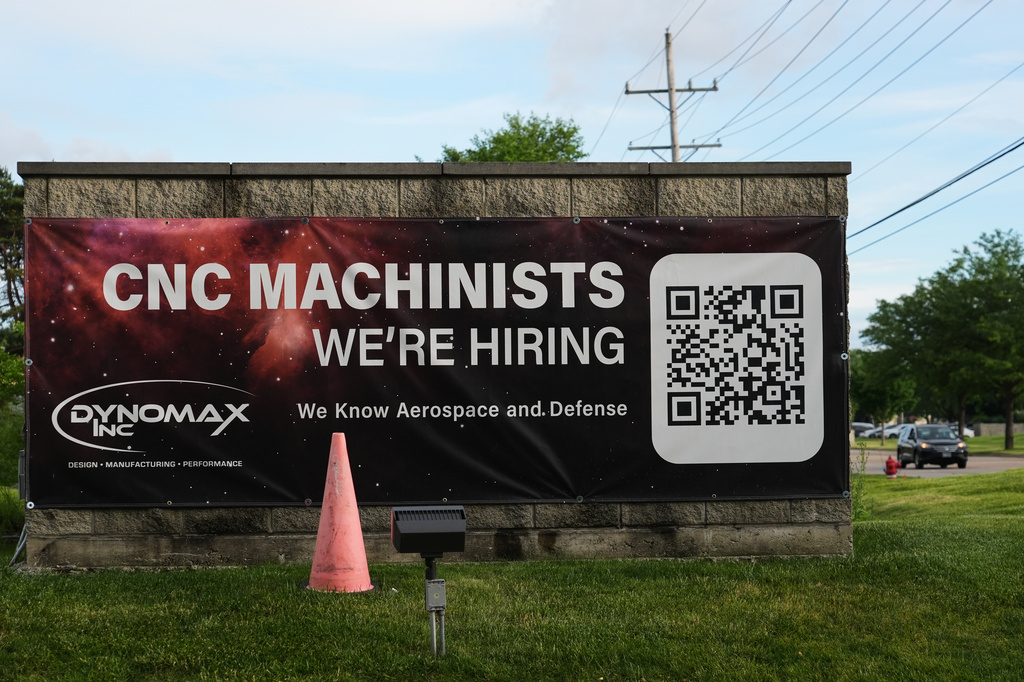 A hiring sign is seen outside of a company in Wheeling, Ill., Monday, June 8, 2026. (AP Photo/Nam Y. Huh)