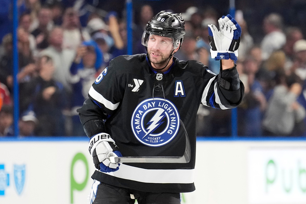 Tampa Bay Lightning right wing Nikita Kucherov (86) waves to the fans after picking up an assist, for his 1,000th career point, on a goal by Brayden Point during the second period of an NHL hockey game against the Anaheim Ducks Saturday, Oct. 25, 2025, in Tampa, Fla. (AP Photo/Chris O'Meara)
