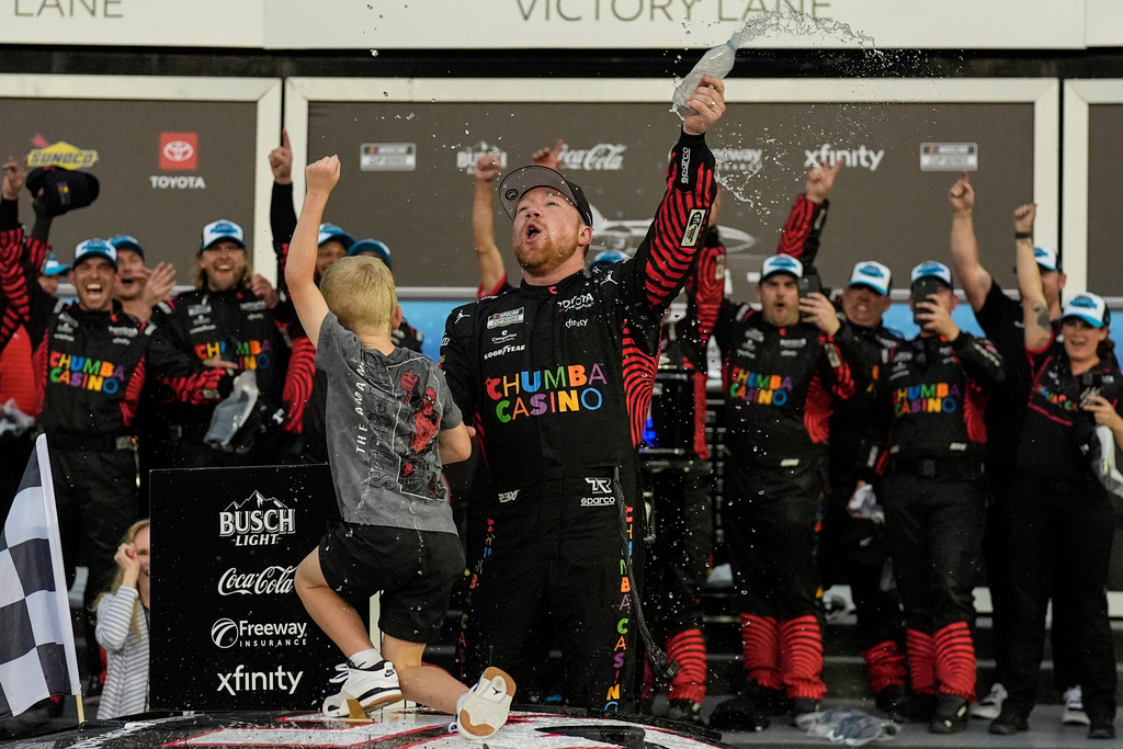 Tyler Reddick, (45) and his son Beau celebrate with the team after winning the NASCAR Daytona 500 auto race at Daytona International Speedway, Sunday, Feb. 15, 2026, in Daytona Beach, Fla. (AP Photo/Mike Stewart)