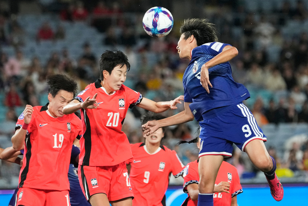 Japan's Riko Ueki, right, heads the ball during the Women's Asian Cup semifinal soccer match between Japan and South Korea in Sydney, Wednesday, March 18, 2026. (AP Photo/Rick Rycroft)