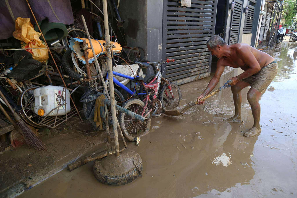 Residents clean up outside their homes after Typhoon Kalmaegi caused devastation in communities at Talisay City, Cebu province, central Philippines, Wednesday, Nov. 5, 2025. (AP Photo/Jacqueline Hernandez)