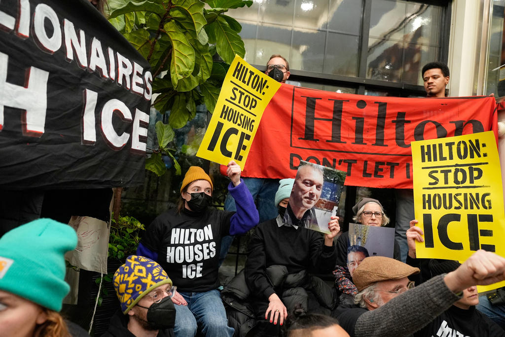 Protesters stage a sit-in in the lobby of a Hilton Garden Inn in New York, Tuesday, Jan. 27, 2026. (AP Photo/Seth Wenig)